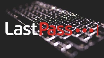 Logotipo del gestor de contraseñas LastPass sobrepuesto a la imagen desenfocada de un teclado retroiluminado en la oscuridad.