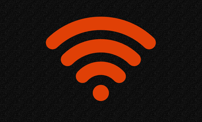 Símbolo de señal Wi-Fi en color naranja sobre un fondo negro con textura granulada.