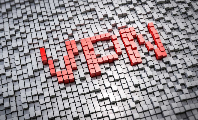 Siglas VPN formadas por cubos rojos sobre una cuadrícula de bloques grises.