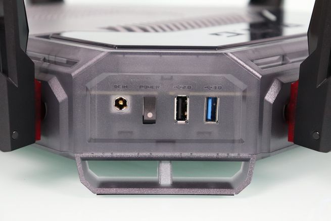 Primer plano de los puertos USB y la entrada de corriente en el chasis del router ASUS GT-BN98.