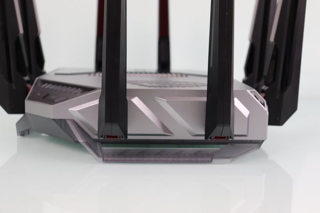 Detalle del lateral del router ASUS GT-BN98 con relieves geométricos y base de las antenas.
