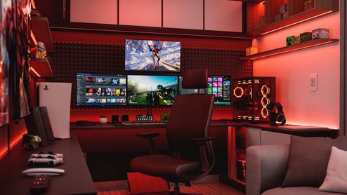 Habitación tipo setup gaming con varios monitores, torre de PC iluminada y consola, en un entorno con luces LED rojas.
