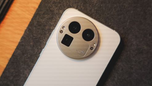Detalle del módulo de cámaras circular en la parte trasera de un teléfono realme de color blanco.