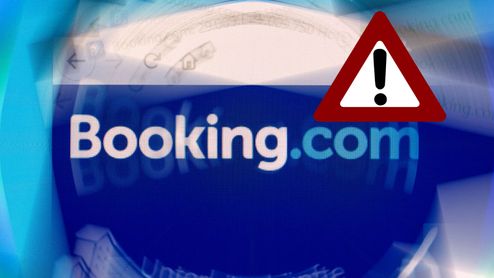 Logotipo de Booking.com con un icono de advertencia triangular de color rojo superpuesto.