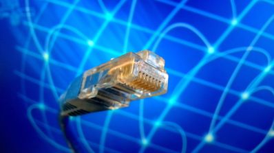 Primer plano de un conector de cable Ethernet RJ45 con fondo digital azul.