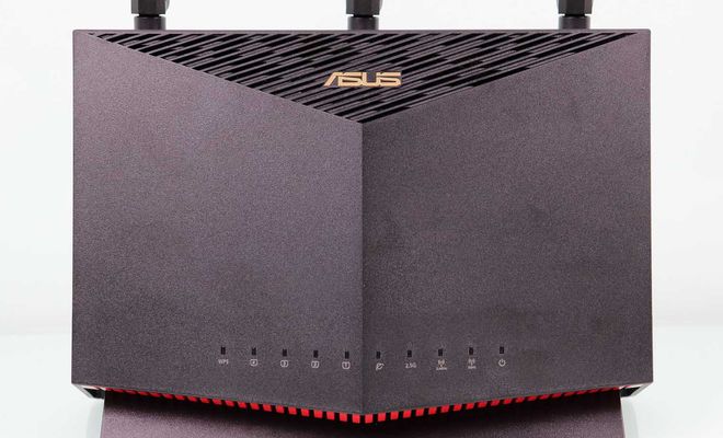 Frontal del router ASUS RT-AX86U en posición vertical con indicadores LED y rejilla de ventilación superior.