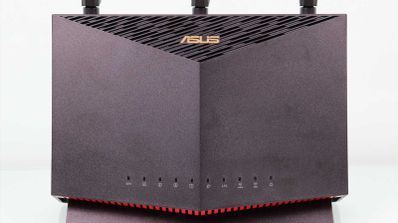 Frontal del router ASUS RT-AX86U en posición vertical con indicadores LED y rejilla de ventilación superior.